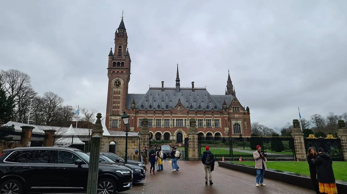 Photo of the International Court of Justice in the Hague, Netherlands. It is a brown building with a tall tower on the left end. Photo of the International Court of Justice in the Hague, Netherlands. It is a brown building with a tall tower on the left end.