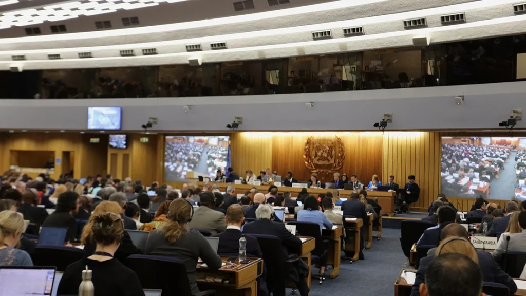 People in suits sitting in the plenary of the International Maritime Organization (IMO) in London at climate change negotiations.