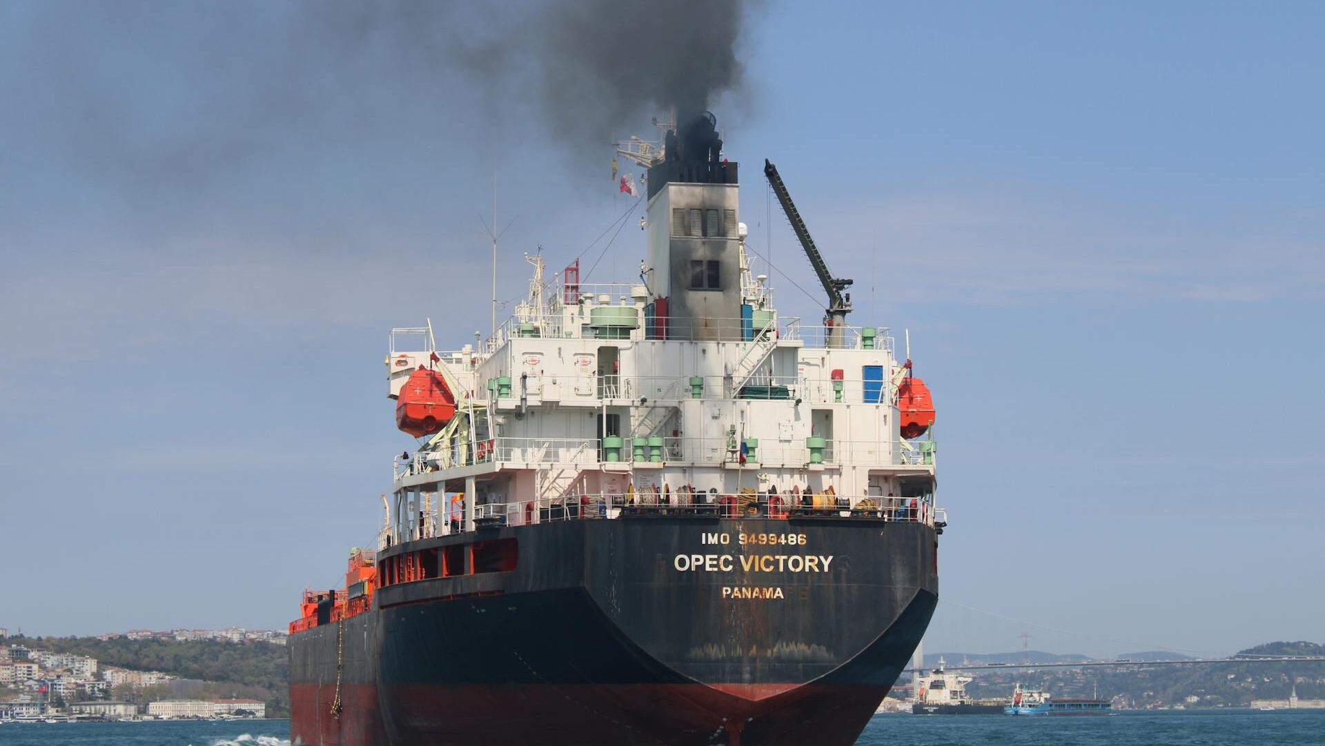Opec Victory heavy freight ship emitting black smoke near land Opec Victory heavy freight ship emitting black smoke near land