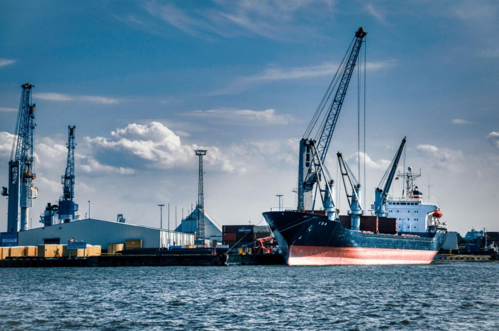 A freight ship loading at a dock
