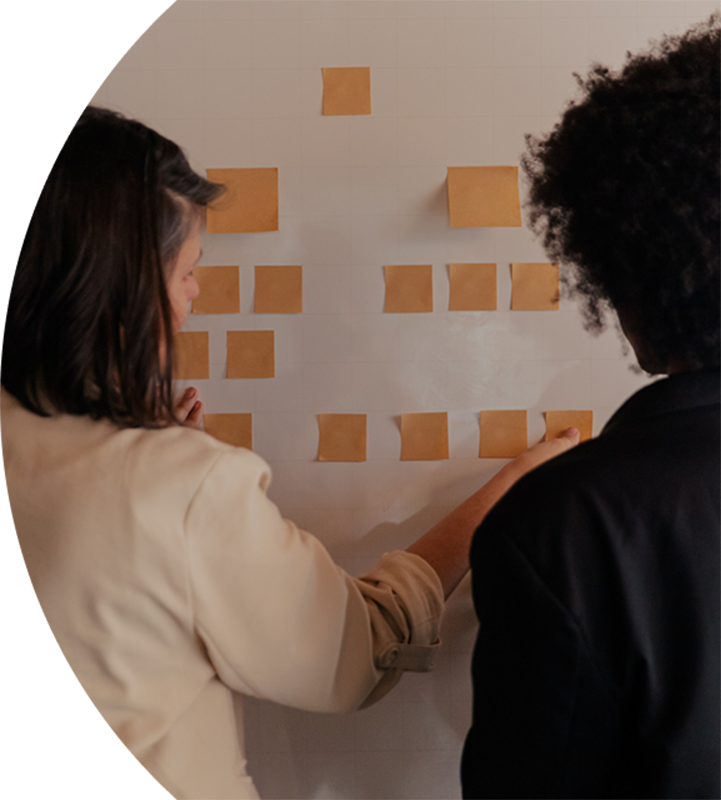 Collaboration with sticky notes at a whiteboard