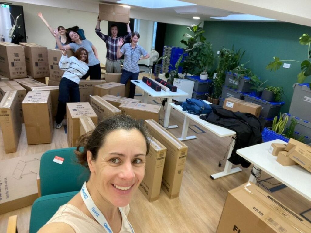 Suki and five Opportunity Green colleagues are surrounded by boxes as they move into a new office in London