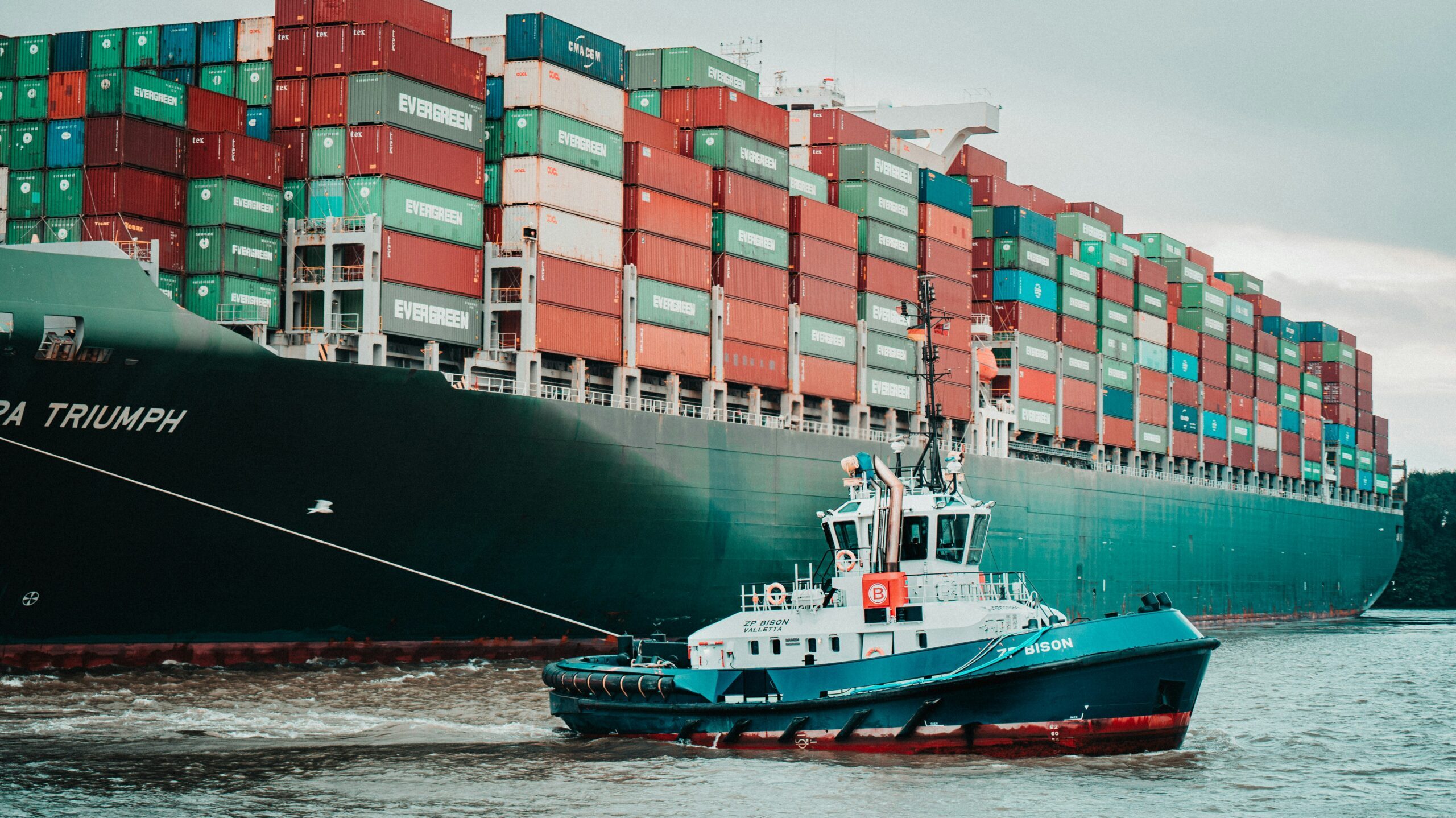 Tug boat attached to cargo ship Tug boat attached to cargo ship