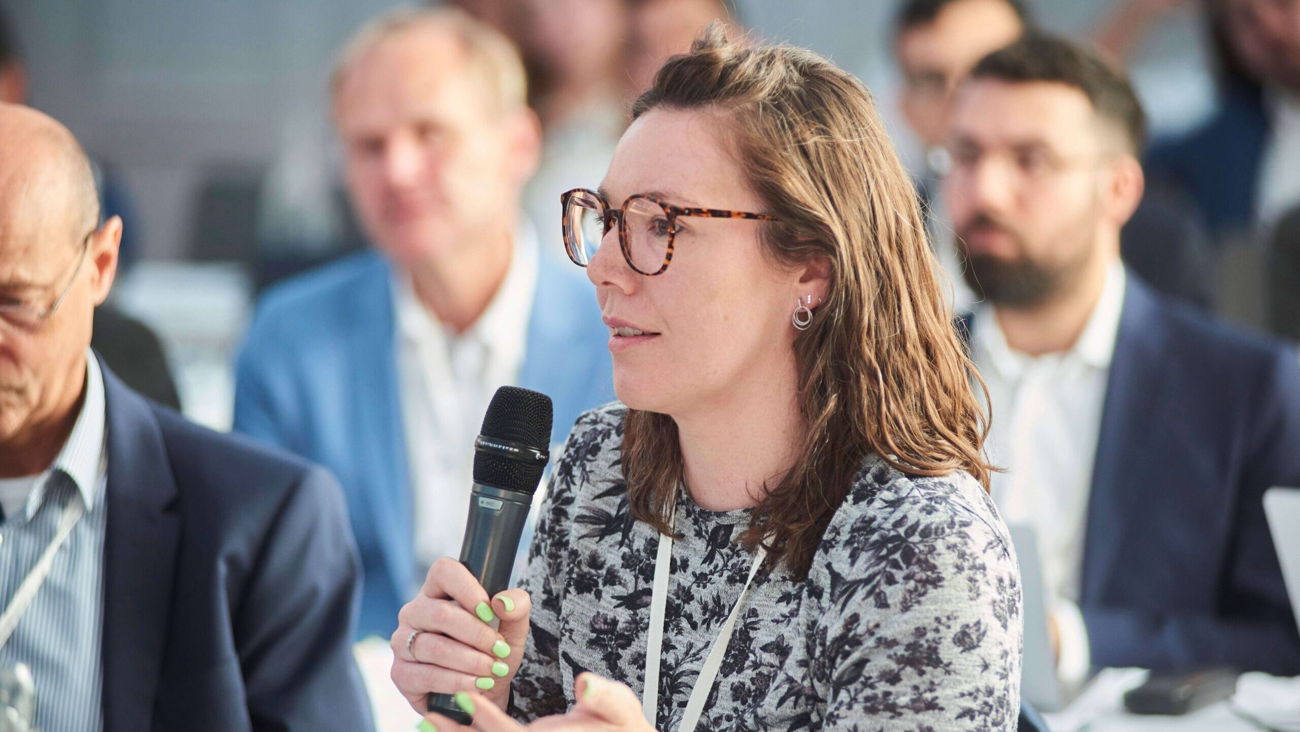 Aoife O'Leary speaking with microphone. TTDS
