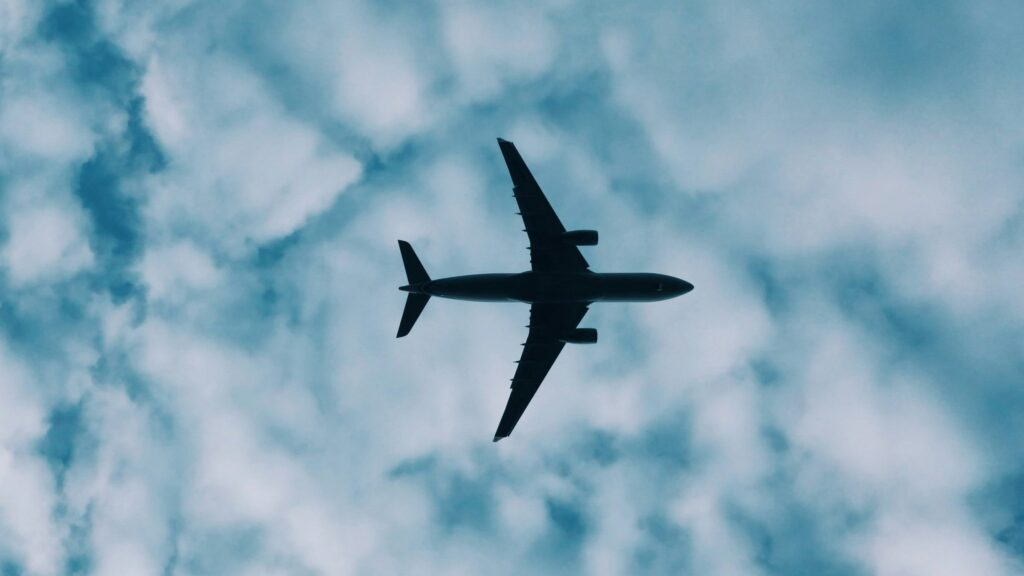Plane flying through a cloudy sky