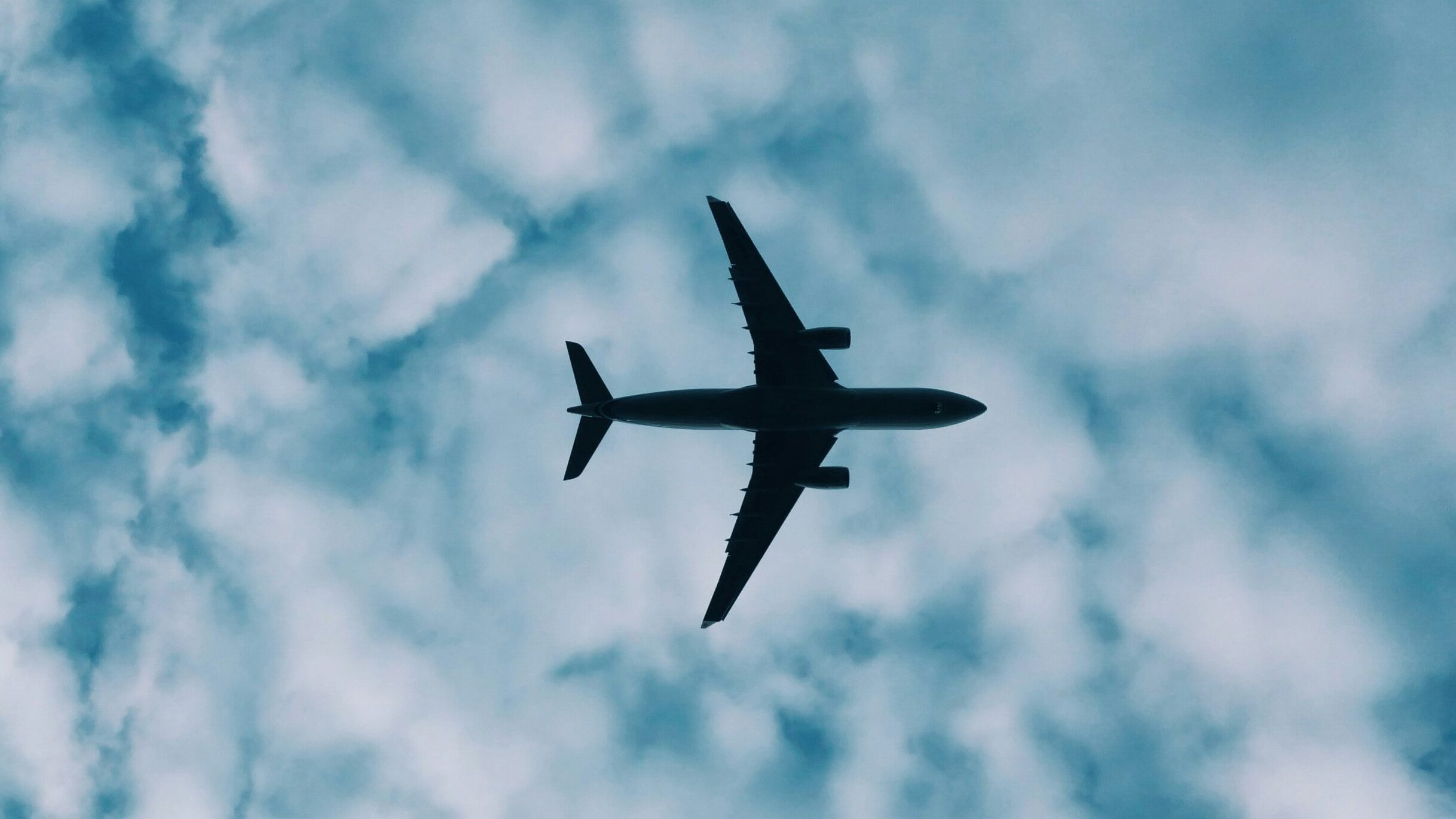 Plane flying through a cloudy sky